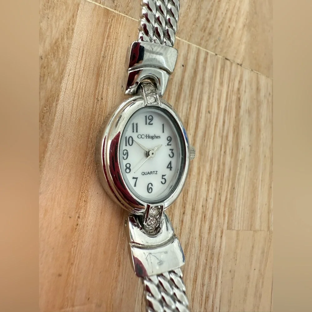 CC Hughes ladies oval silver tone watch NEW BATTERY